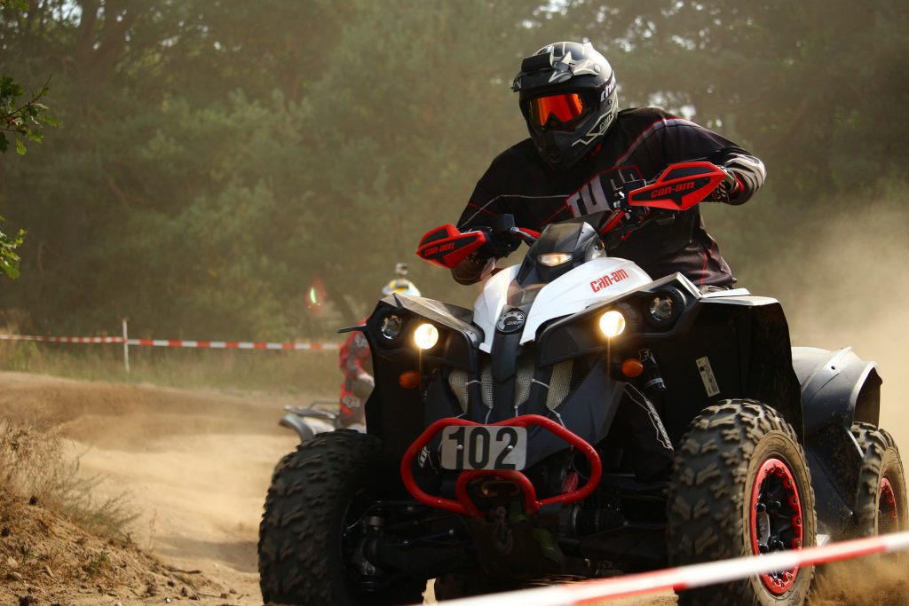 Skid steer attachments. Guy on ATV four wheeler